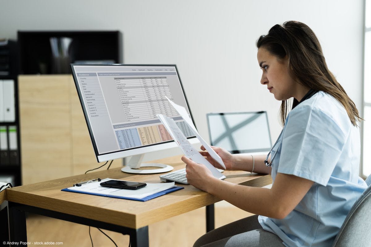 woman doctor working on paperwork at computer